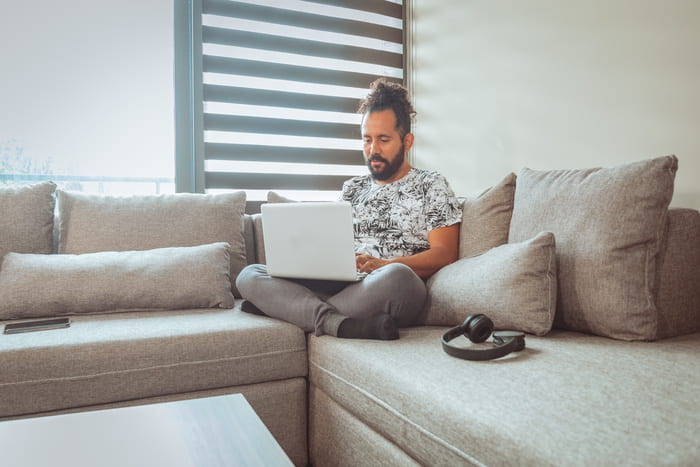 hombre con laptop en un sillón